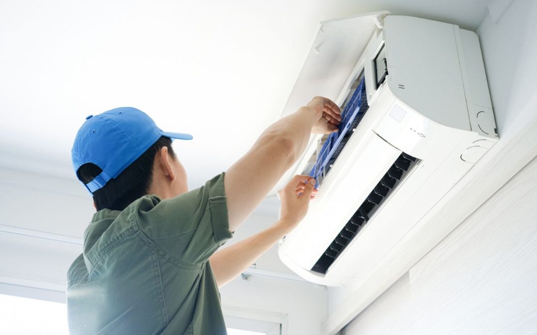 Air conditioning technician maintaining an indoor mini split system in Gilbert, AZ