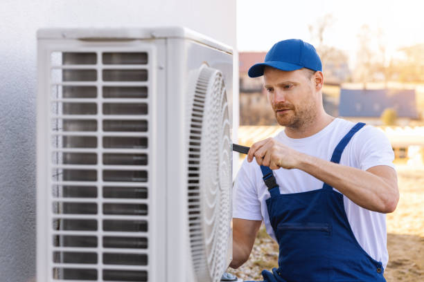 HVAC technician servicing an outdoor air conditioning unit in Gilbert
