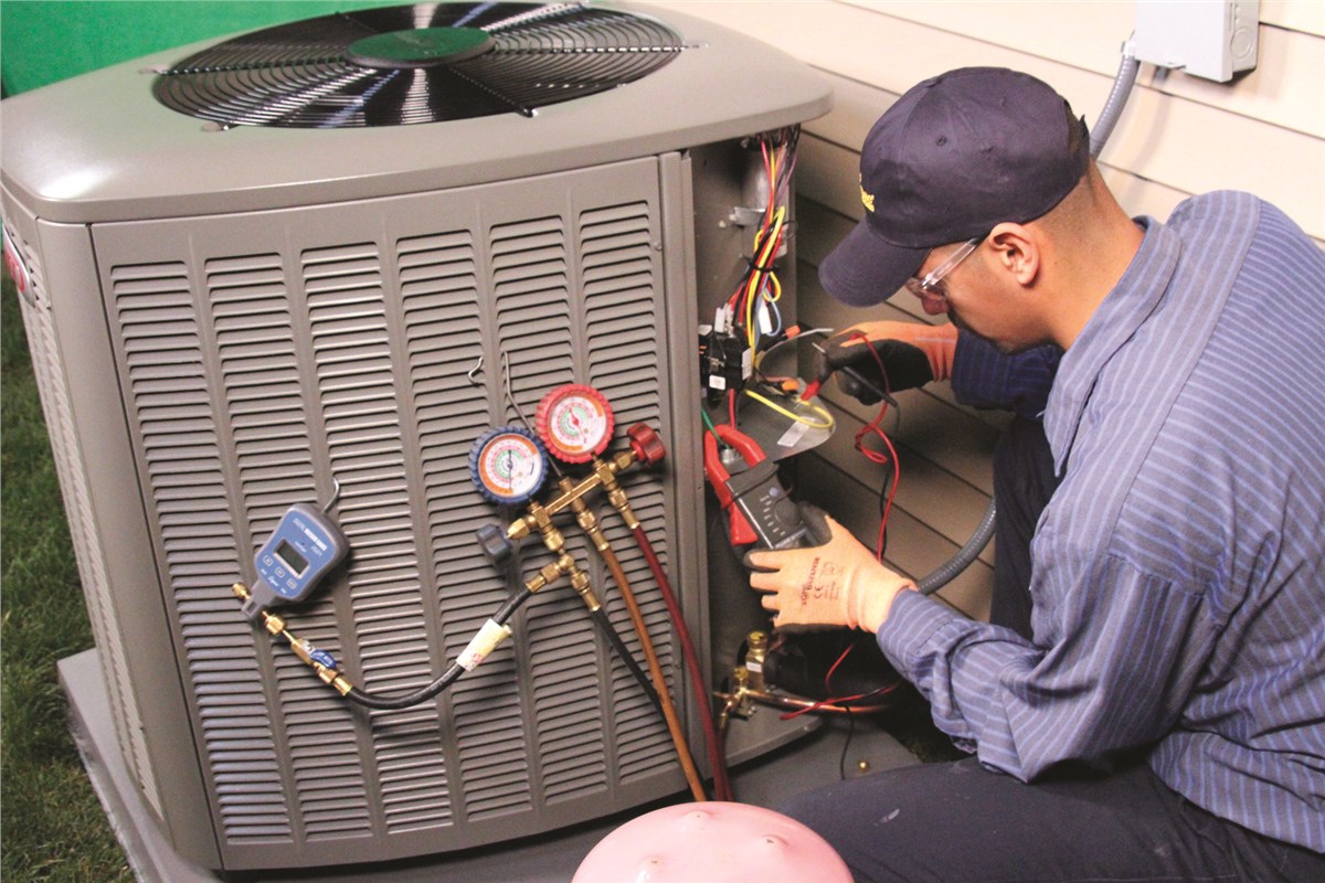 HVAC technician testing an outdoor air conditioning unit in Gilbert