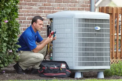 HVAC technician inspecting an outdoor air conditioning unit in Gilbert, AZ